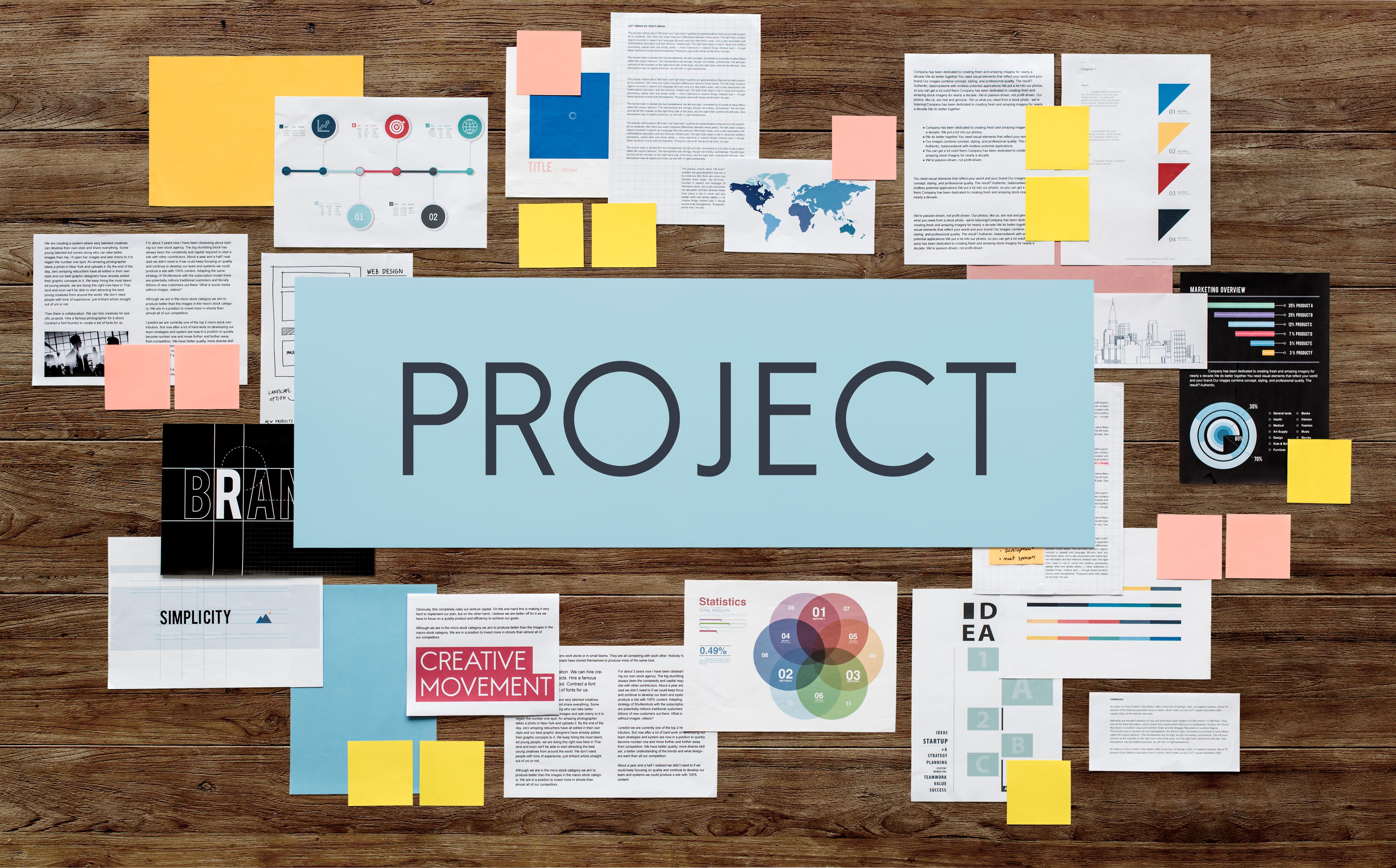 Image of the word PROJECT and with lots of documents behind it.