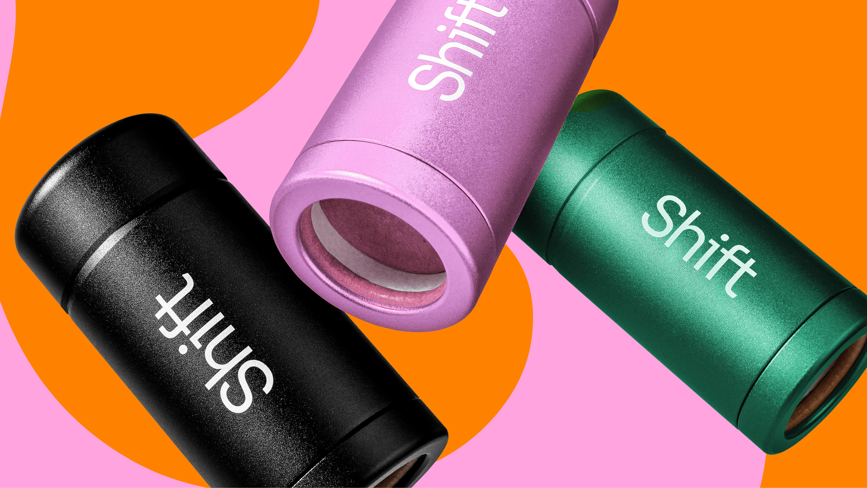 Three metal deodorant containers in black, pink and green, with a pink and orange background with the name &#34;shift&#34; on them